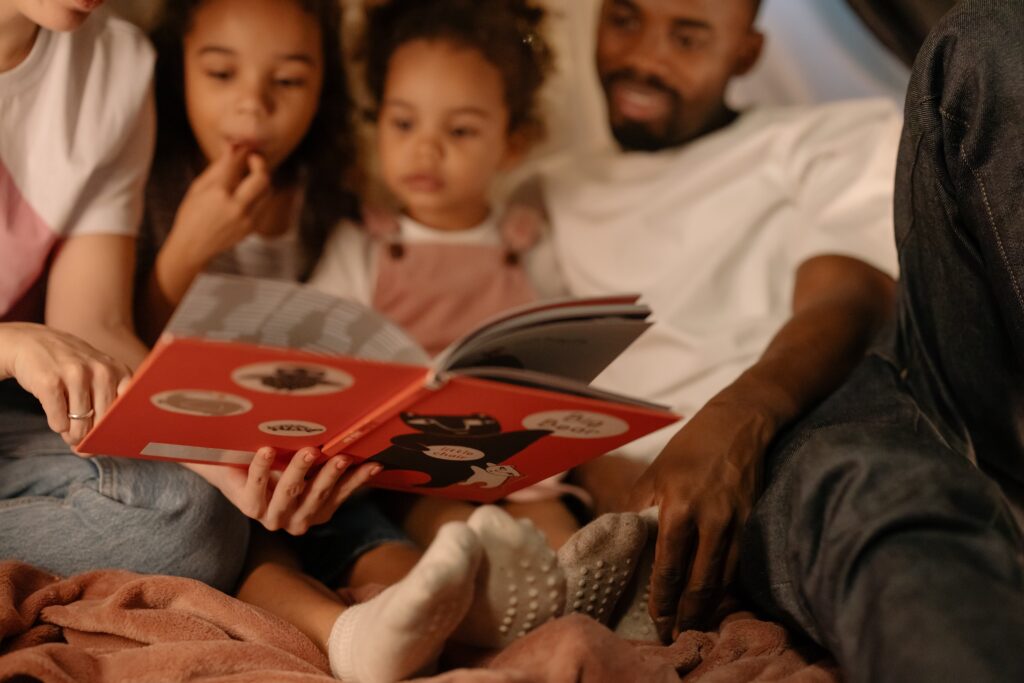 image of family reading a book